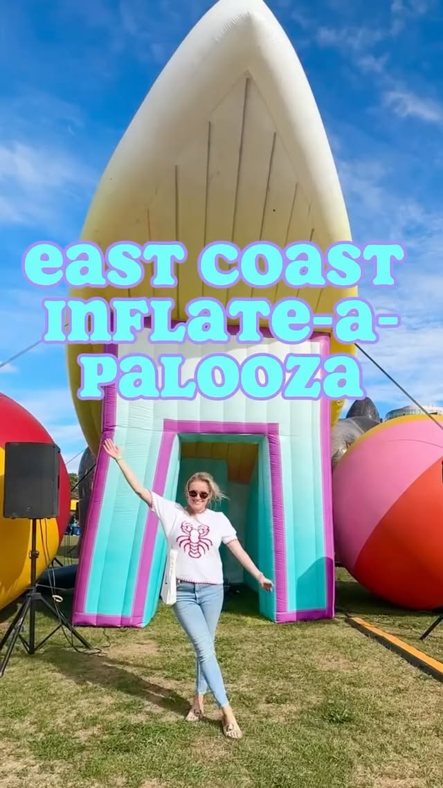 Attendee posing in front of giant inflatable displays